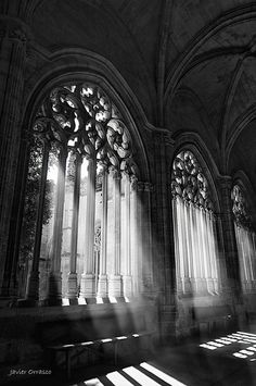 sunlight streams through the windows in an old cathedral