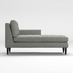 a gray couch sitting on top of a white floor