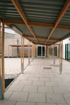 an empty covered area with benches and tables