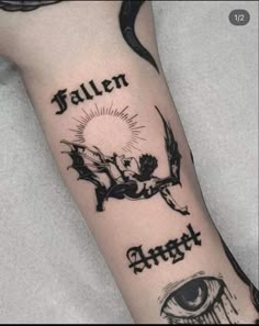 a person with a tattoo on their arm that says, fallen angel and an eye