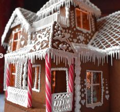 a gingerbread house with icing and candy canes