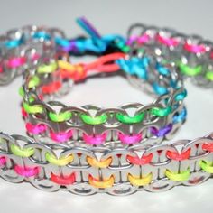 several different colored bracelets on a white surface