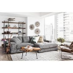 a living room filled with furniture and lots of windows