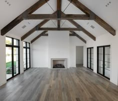 an empty room with wood floors and white walls