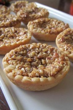 several small pies are on a white plate