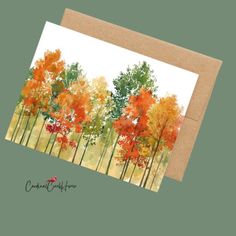 a card with an orange and green forest scene