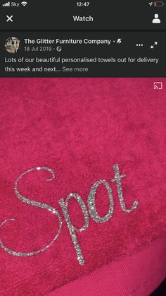 a pink towel with the word spot written on it in cursive silver ink