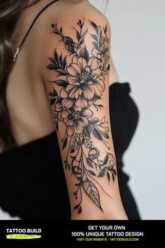 a woman's arm with flowers and leaves tattooed on the side of her shoulder