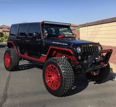 a black and red jeep parked in a parking lot