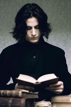 a man sitting at a table reading a book