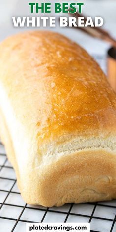 a loaf of white bread sitting on top of a cooling rack