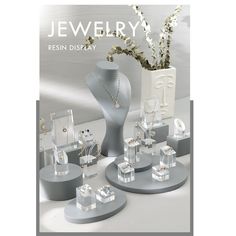 an advertisement for jewelry displayed in front of a vase with flowers and other items on it