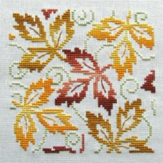 a cross stitch pattern with autumn leaves