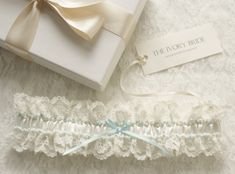 The romantic Classic Garter, made from soft Ivory satin which is trimmed with Ivory lace and decorated in blue pearl and Ivory pearl detailing, finished with a blue satin hand tied bow Every garter Is handcrafted here In England, all fabric and lace is hand cut, all embellishments and decoration and each bead is carefully hand sewn on to give a complete authentic handcrafted product. Each Garter is presented In a quality keepsake gift box finished with a luxurious satin ribbon bow, your garter w Ivory Bride, Romantic Classic, Bow Wedding, Satin Hands, Satin Ribbon Bow, Bridal Garter, Ivory Pearl, Wedding Keepsakes, Pearl Wedding