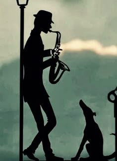 a silhouette of a man playing the saxophone next to a dog on a street light