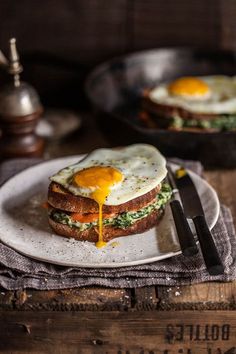 an egg sandwich is on a white plate