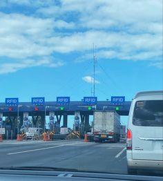 an overpass with cars and trucks driving under it on a road that has traffic cones in front of it