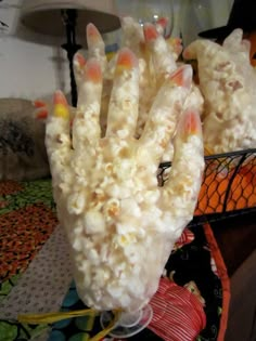 a hand made out of popcorn sitting on top of a table next to a lamp