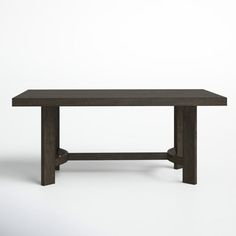 a wooden table sitting on top of a white floor