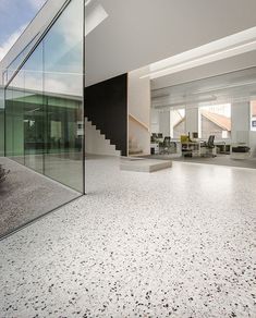 an empty room with glass walls and stairs