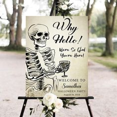 a welcome sign with a skeleton holding a wine glass in it's right hand