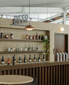 an empty bar with bottles on the shelves