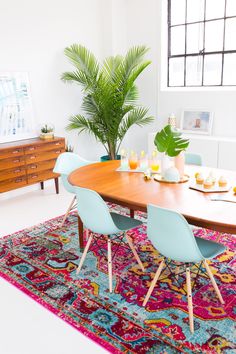 a dining room table with chairs and a rug