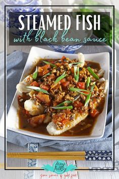 steamed fish with black bean sauce in a white bowl on a blue and white plate