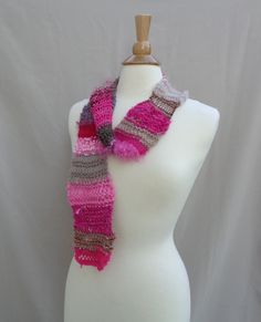 Hand knit skinny art scarf, in a fun mixed-texture designer yarn in pink and brown mix. A perfect accent scarf for Summer and beyond, women and teens alike will find plenty of ways to wear this little cutie. Scarf is lightweight with a lacy, open knit, expect knots as part of the artistic expression. There are several types/textures of yarn for an interesting feel and look - see close-up photo. Average length - allows for this scarf to be looped, knotted. size: width varies from thick to thin 3-3.5 x 72" fiber: natural/synthetic mix care: hand wash, dry flat #3 Scarf For Summer, Art Scarves, Brown Art, Pink And Brown, Wrap Scarf, Scarf Women, Artistic Expression, Open Knit, Fashion Chic