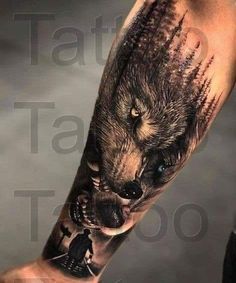 a man's arm with a wolf tattoo on it