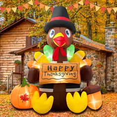 an inflatable thanksgiving turkey holding a happy thanksgiving sign