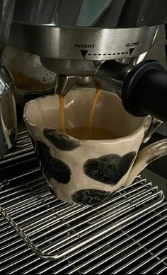 coffee being poured into a white cup