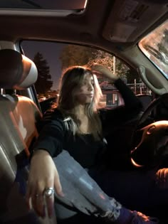 a woman sitting in the passenger seat of a car