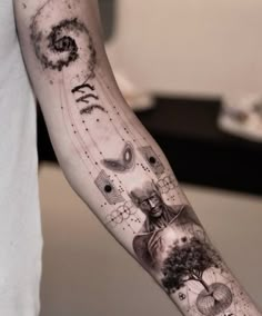 a person with a tattoo on their arm that has many things in the sky above them