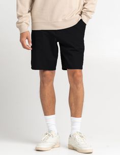 Rsq Mid-Length Chino Shorts. Falls Above The Knee. Slant Hand Pockets. Zip Fly. Button Waist. Dual Back Welt Pockets With Rsq Logo Flag At Left Side. Approximate Inseam: 9". Approximate Outseam: 19.5". 76% Cotton 21% Repreve Recycled Polyester 3% Spandex. Machine Wash. Imported. | Rsq Mid Length 9" Chino Shorts