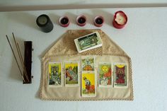 a table topped with cards and candles on top of a white counter