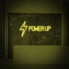 a neon sign that reads power up on the wall