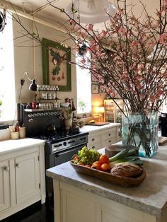 a kitchen with an island and flowers in a vase