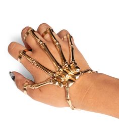 All that grabs is gold. Your hand is your most precious asset that you always forget to thank – but that’s about to change with the Gold Skeleton Finger Bracelet. Match your skeleton jumpsuit, bodysuit or dress with this powerful accessory and forget your phalanges no more. Gold Metal Jewelry For Costume Party, Gold Jewelry For Costume Party, Ribcage Fashion, Gold Halloween Party Jewelry, Adjustable Gold Jewelry For Halloween, Skeleton Jumpsuit, Golden Halloween, Skeleton Outfit, Skeleton Hand Bracelet