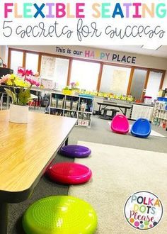 a classroom with tables, chairs and colorful bean bag stools on the floor in front of them