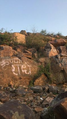 graffiti on the side of a rocky hillside