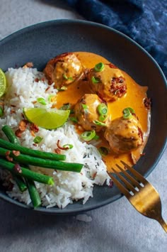 thai chicken meatballs with rice and green beans on a plate