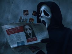 a person in a mask reading a newspaper