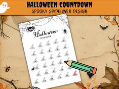 a sheet of paper with halloween stickers on it and a pencil in the middle