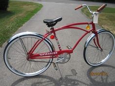 a red bicycle parked on the side of a road