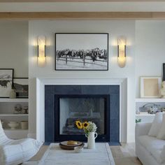 a living room filled with furniture and a fire place in front of a painting on the wall