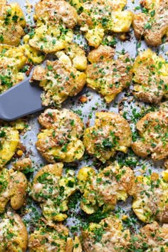 a pan filled with broccoli and potatoes covered in parmesan sprinkles