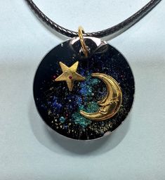 I used chromatic mica pigments to make the background look like the universe. I used silver, gold, and rose gold colored stars, moons, and planets to put in the pendants. These came out so cool! All necklaces come on a black lanyard cord necklace.  If you would like more pictures of a certain piece, please reach out to me in messages.  Please use a soft cloth/lens wipe to clean off. Resin is pretty resistant but not 100% and can be scratched, please be careful when wearing/storing. Please keep r Galaxy Necklace, Black Lanyard, Moon Space, Stars Moon, Colour Star, Shooting Star, Reach Out To Me, Shooting Stars, Cord Necklace