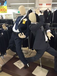 two mannequins dressed in suits and ties are dancing