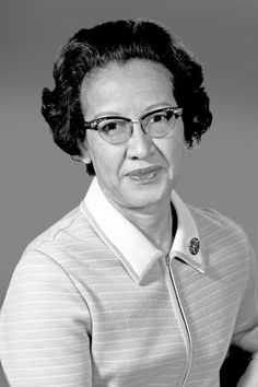 an old black and white photo of a woman in glasses with her hands on her hips